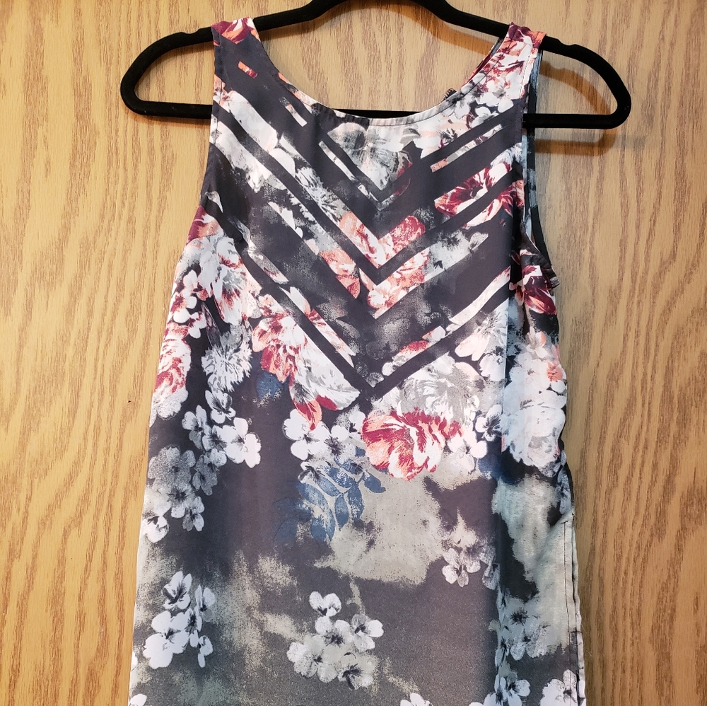 Beautiful semi sheer blouse with zipper in back and side splits. Like new.